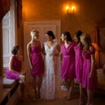 karl bratby photographer.071 Bride and her 5 bridesmaids in the preparation room discussing and laughing before the marriage ceremony.