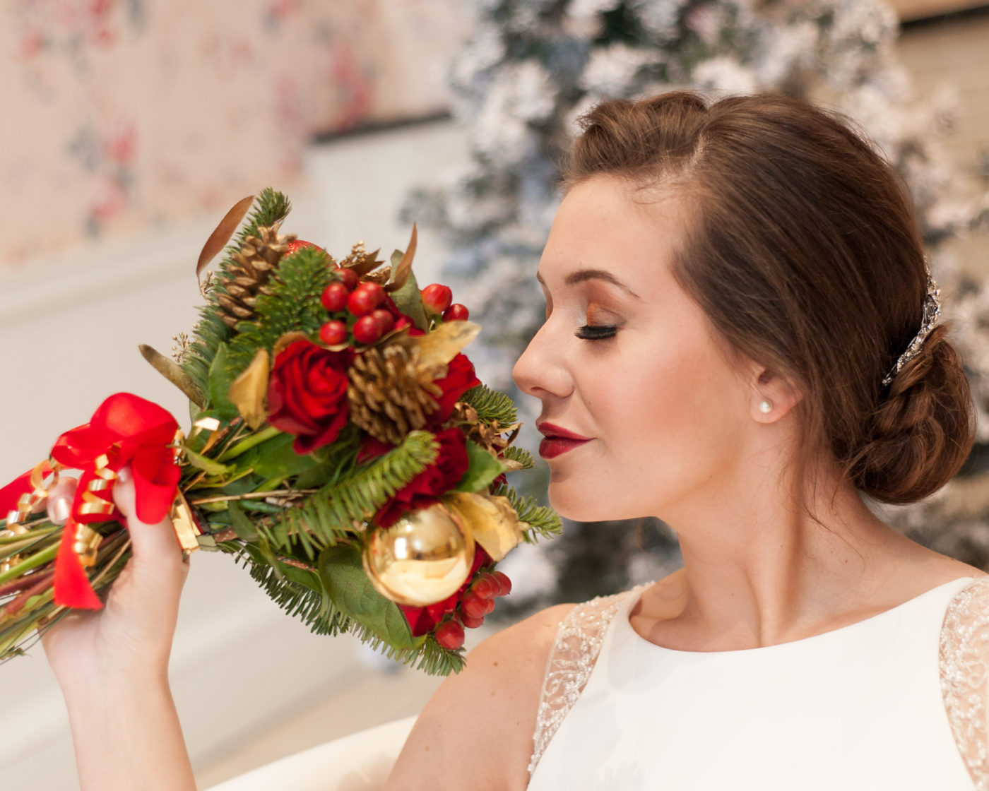 Bride smelling Christmassy bouquet