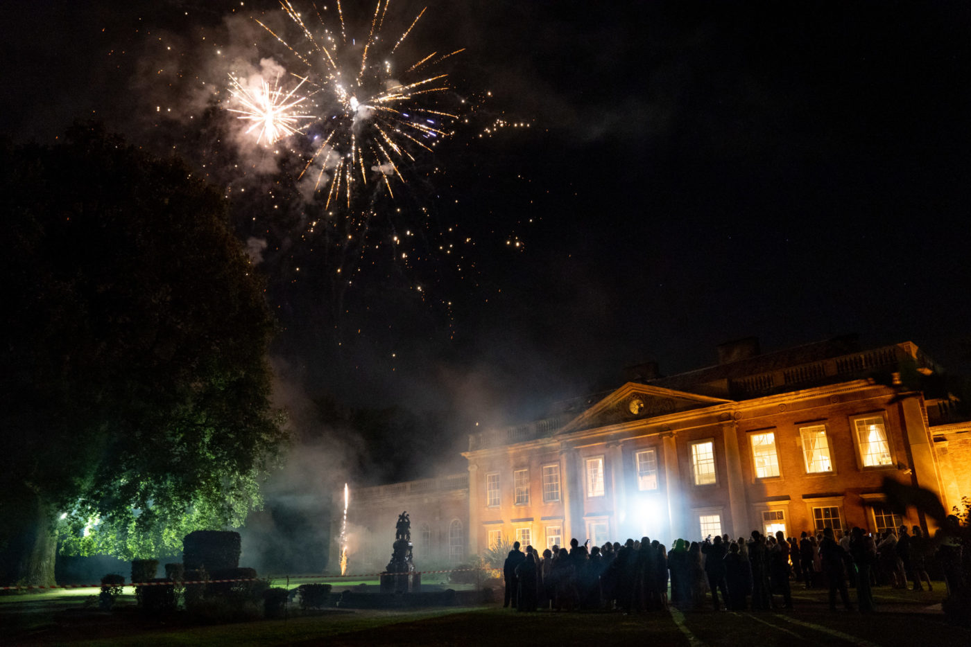 Gold fireworks bursting in front of the Colwick Hall.