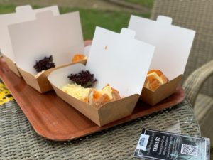 Boxes of jacket potato meals sat on tray on outdoor table