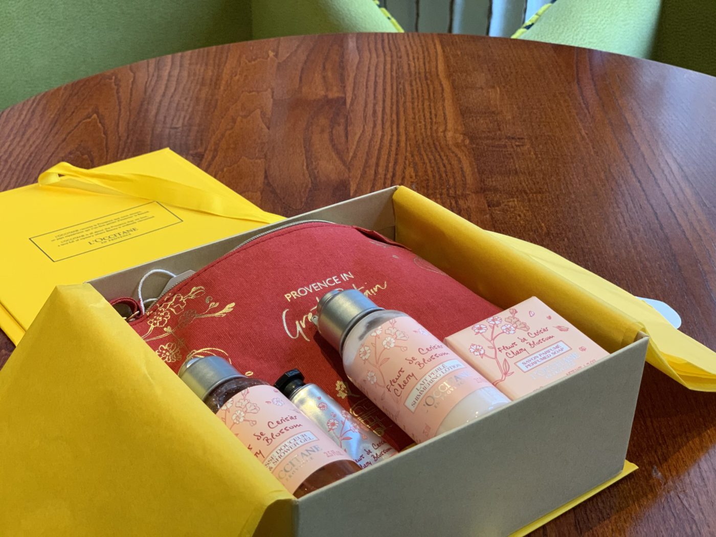 Luxury box open full of toiletries sat on wooden table