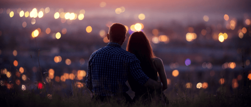 a couple looking out over the city celebrating their anniversary