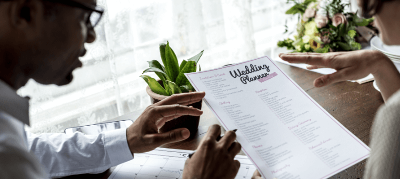a couple working through a wedding checklist