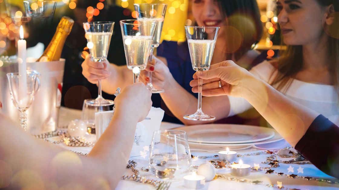 Table of guests cheers at Christmas party